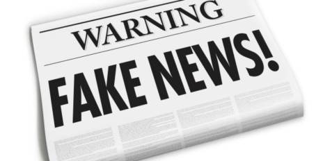 Vector image of newspapers that have big headlines saying: "Warning FAKE NEWS!"